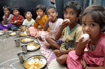 Kids enjoying healthy meals at Anganwadi center day care.