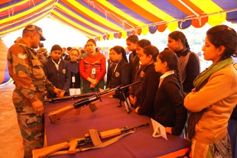 Female students admiring the arms and ammunition on display.